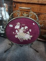 A brass with tapestry mounted fire screen