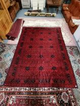 A 3.5m x 2.5m red large rug