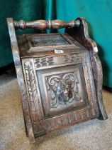 A Victorian carved oak coal box