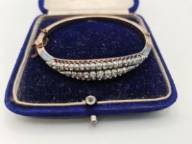 Victorian 9ct and silver hinged bangle with three rows of diamonds