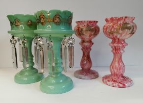 A pair of Victorian glass lustres in green with floral decoration and also a beautiful pair of red,