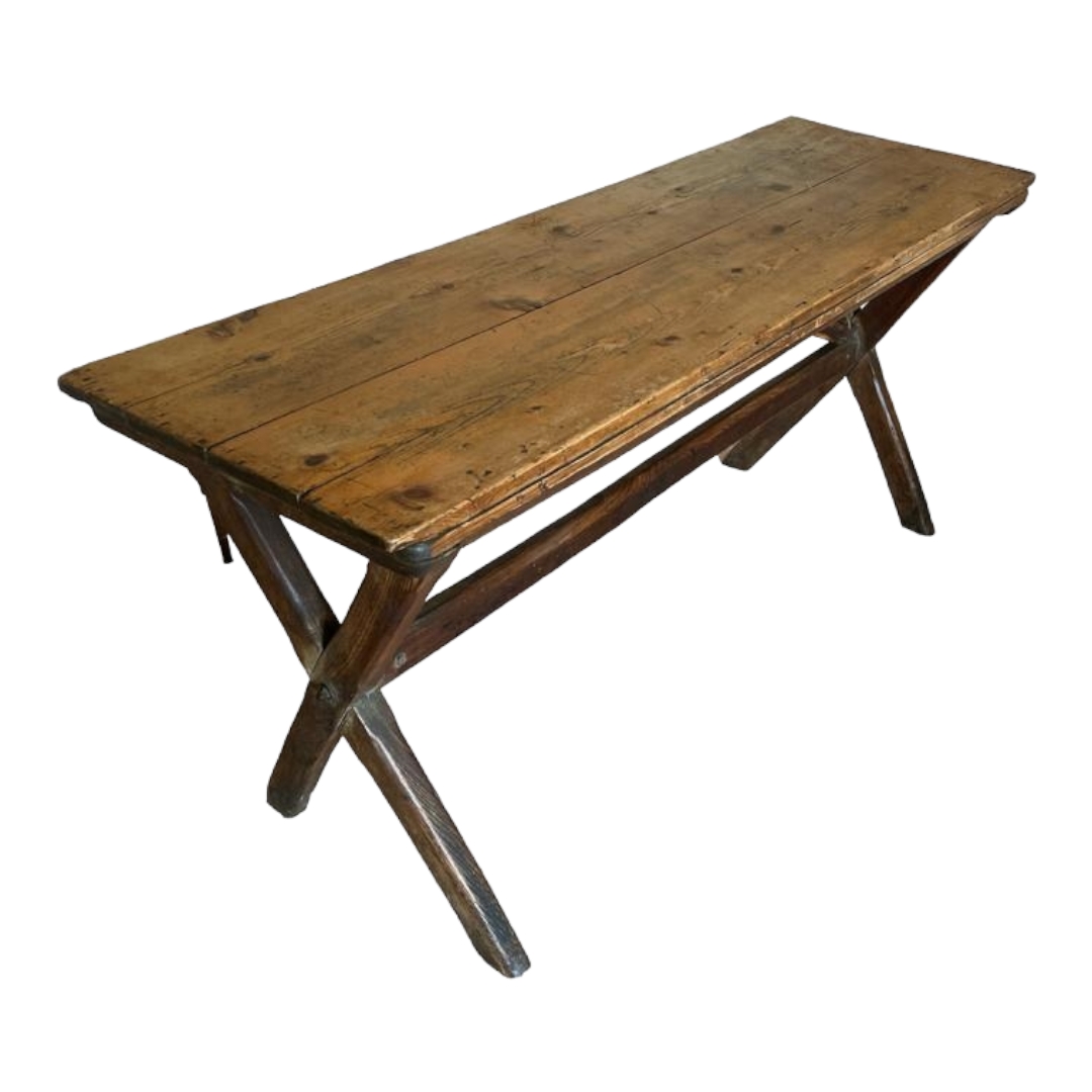 A 19TH CENTURY PINE DINING TABLE The two plank top raised on cross legs joined by a stretcher. (