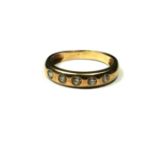 A VINTAGE YELLOW METAL AND DIAMOND HALF ETERNITY RING Having a row of round cut diamonds in a