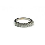 AN 18CT WHITE GOLD AND DIAMOND HALF ETERNITY RING The single row of round cut diamonds. (approx