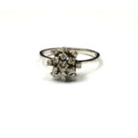 A VINTAGE 18CT WHITE GOLD AND DIAMOND CLUSTER RING Having an arrangement of round cut diamonds