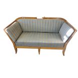 AN EARLY 20TH CENTURY SATIN WALNUT TWO SEAT SETTEE With pierced fretwork panels, upholstered seat