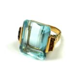 A VINTAGE YELLOW METAL, AQUAMARINE AND CITRINE RING The large step cut aquamarine flanked by two