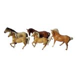 BESWICK, TWO POTTERY MODELS OF RACEHORSES In brown gloss, standing position, two Beswick foals in