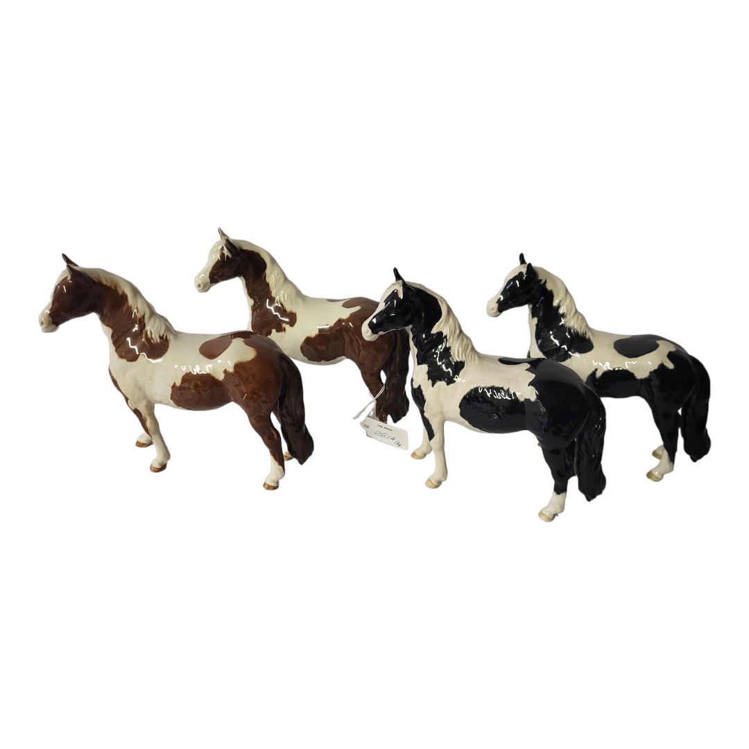 BESWICK, TWO POTTERY MODELS OF WELSH MOUNTAINS OR PINTO PONY Painted in black and white and brown