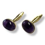 A PAIR OF 9CT GOLD AND AMETHYST GENTS CUFFLINKS Each set with a cabochon cut amethyst. Condition: