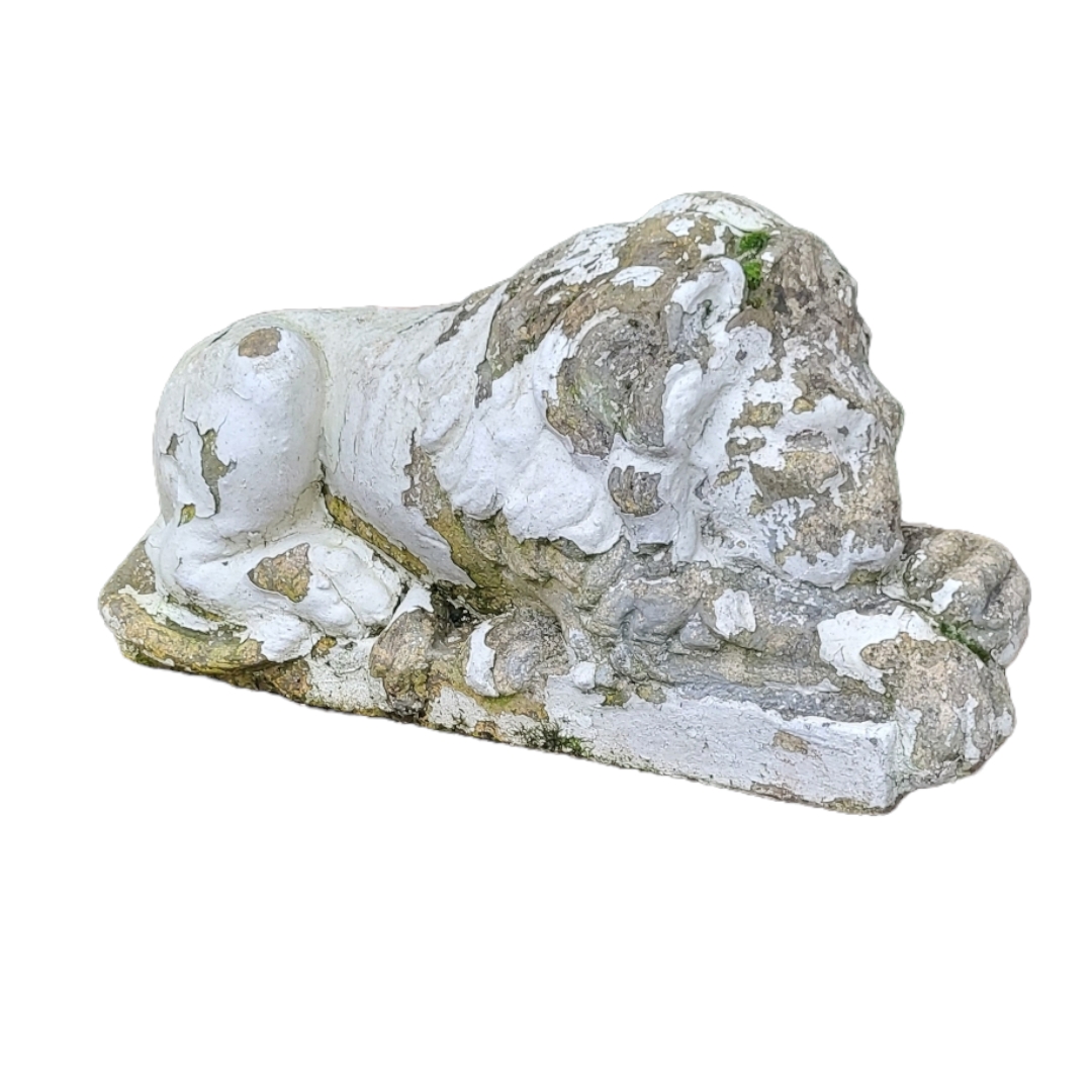 A CAST STONE STATUE, CLASSICAL STYLE RECUMBENT LION. (w 61cm) Condition: weathered
