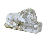 A CAST STONE STATUE, CLASSICAL STYLE RECUMBENT LION. (w 61cm) Condition: weathered