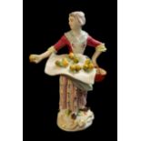MEISSEN, A HARD PASTE PORCELAIN MODEL OF A YOUNG FEMALE FRUIT SELLER, AFTER CRIES OF PARIS, CIRCA