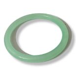 A CHINESE LIGHT GREEN SPHERICAL JADE BANGLE Plain design. (approx diameter 8cm) Condition: good