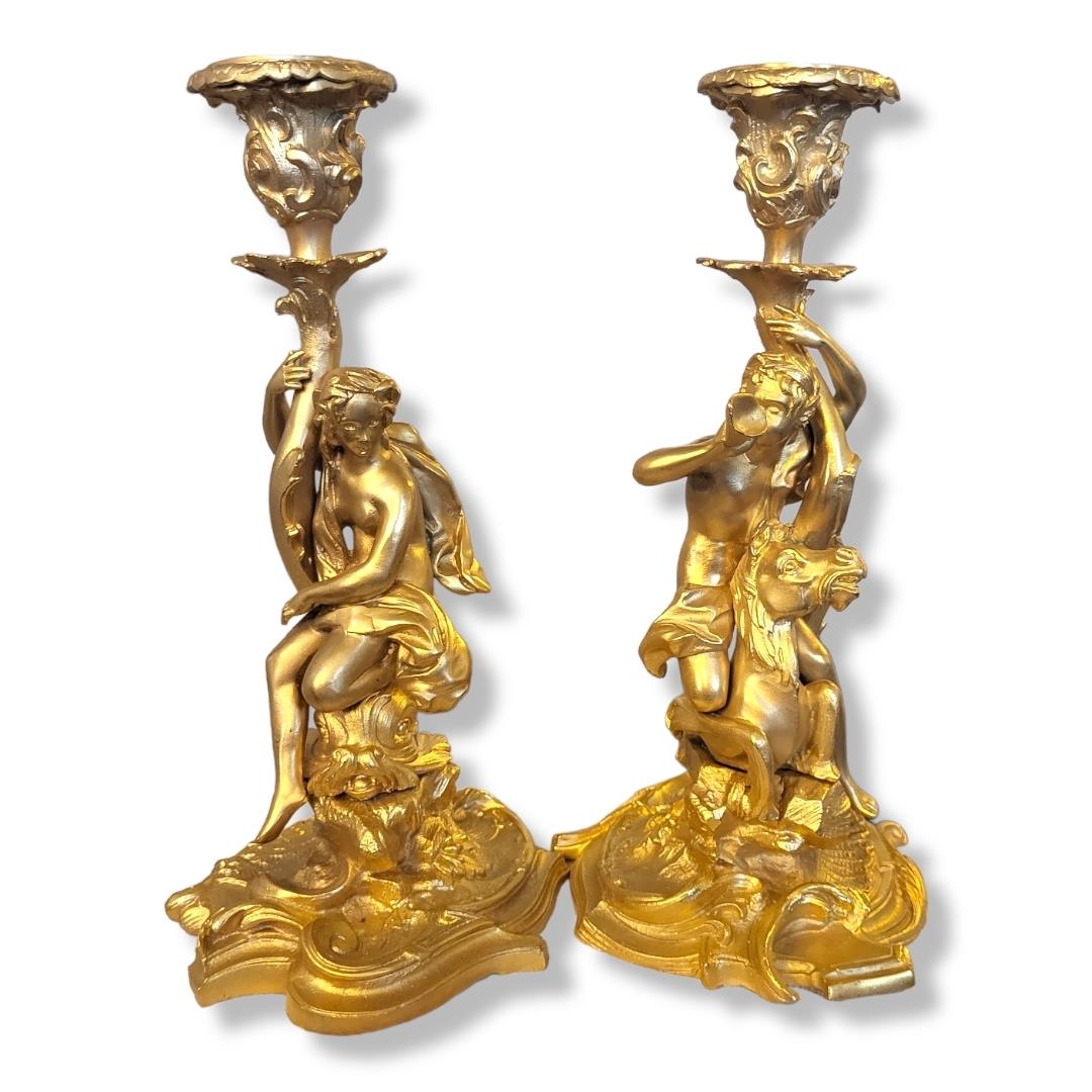 A PAIR OF GILT BRONZE FIGURAL CANDLESTICKS Classical form with a figure riding a horse on a scrolled