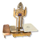 A SET OF EARLY 20TH CENTURY PAINTED CAST IRON BALANCE SCALES Having a lion and shield form finial