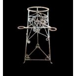 AN ANTIQUE WROUGHT IRON PLANT/STICK STAND With scrollwork decoration on three legs. (75cm)