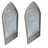 A PAIR OF GOTHIC POINTED ARCH AND IRON GRILLED MIRRORS In distressed grey painted finish. (68cm x