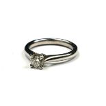 A PLATINUM AND DIAMOND SOLITAIRE RING The single round cut diamond in a plain design. (approx