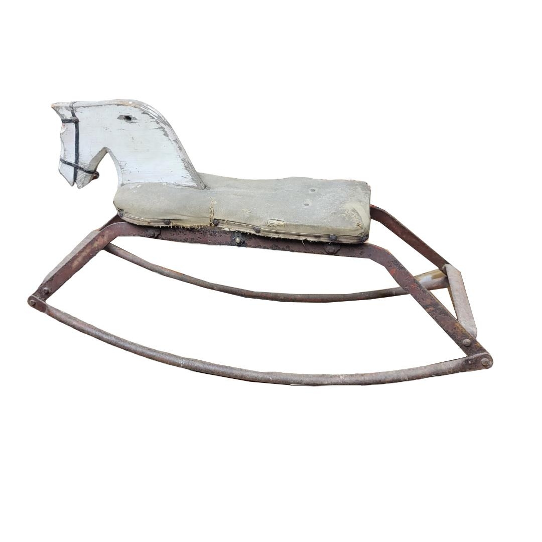AN EARLY/MID CENTURY PAINTED PINE AND IRON CHILDS ROCKING HORSE. (83cm x 46cm) Condition: worn