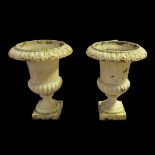 A PAIR OF 19TH CENTURY CAST IRON MELON SECTION URNS With egg and dart rims. (28cm x 37cm) Condition: