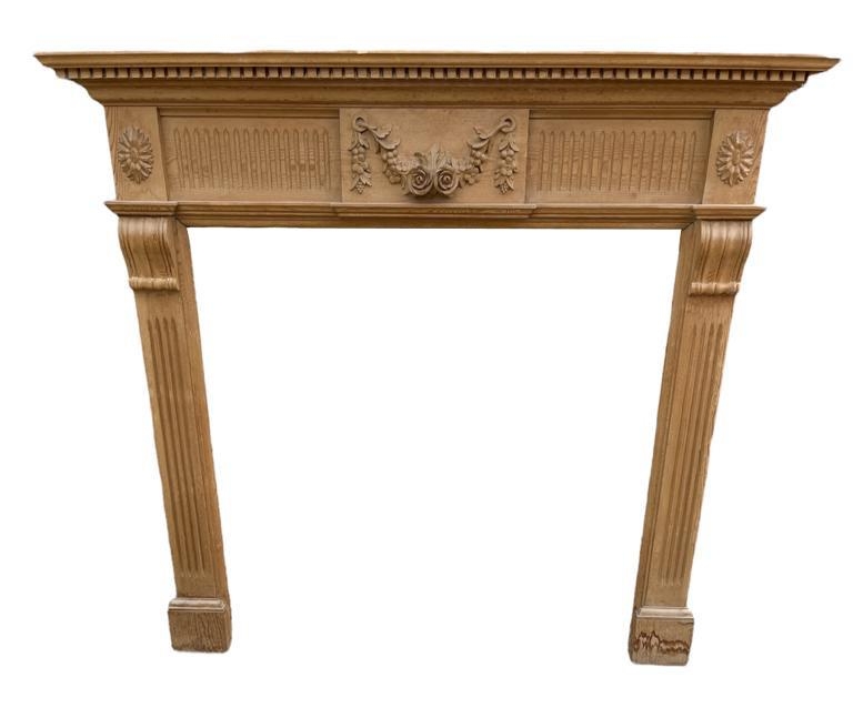 AN ADAMS STYLE PINE FIRE SURROUND With central floral cartouche, along with a scumble decorated