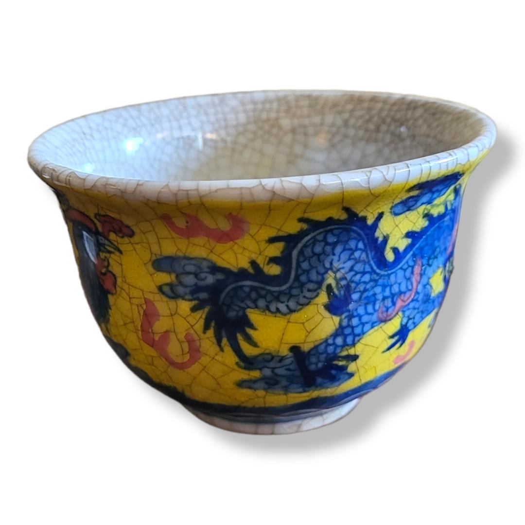 A 20TH CENTURY CHINESE BLUE AND YELLOW TEA BOWL Decorated with a dragon and Phoenix, bearing a six - Image 2 of 2