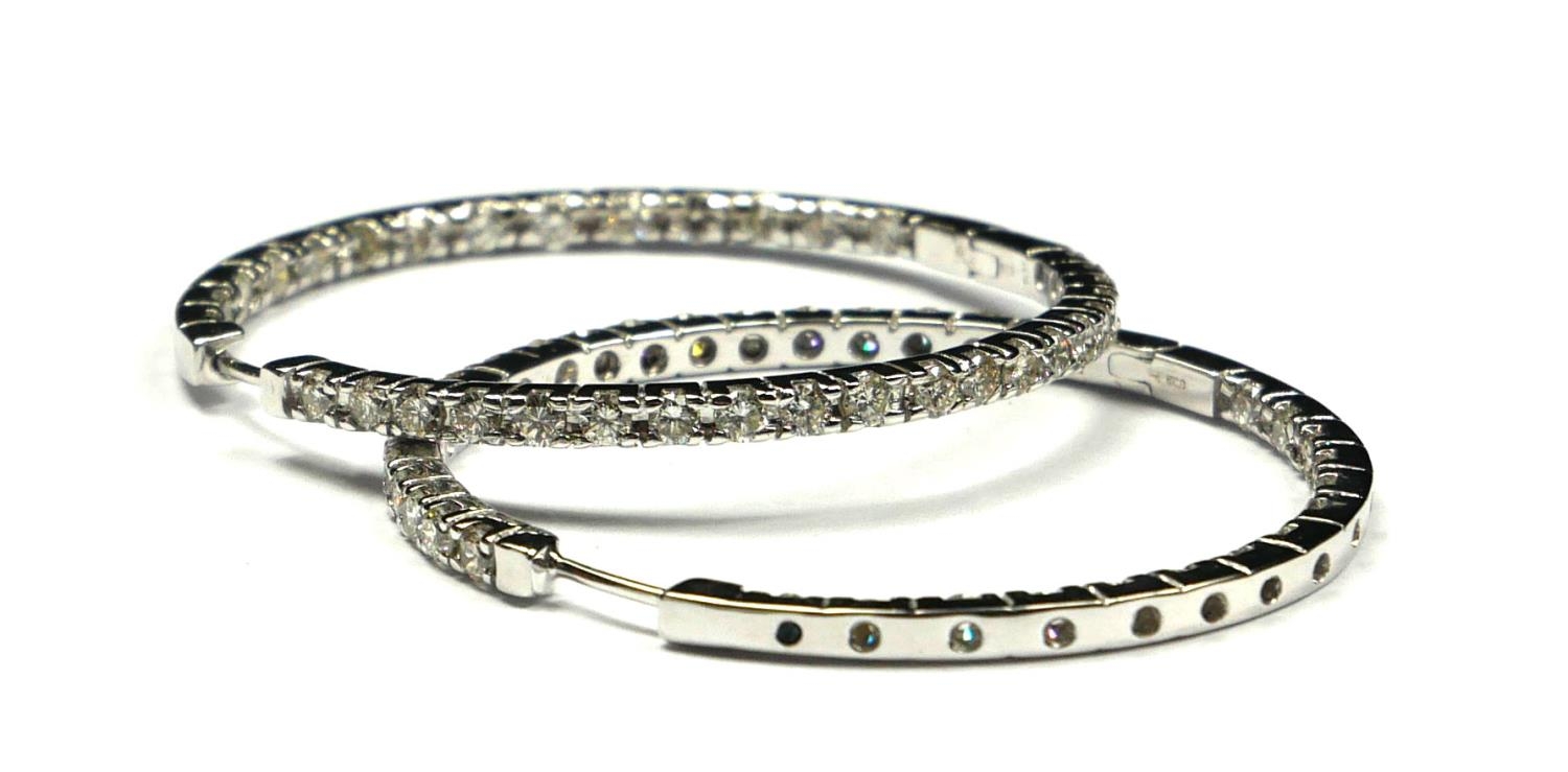 A PAIR OF 18CT WHITE GOLD AND DIAMOND HOOP EARRINGS Each set with two rows of round cut diamonds. (