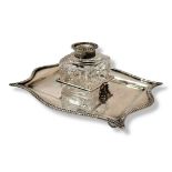 A VICTORIAN SILVER AND CUT GLASS INKSTAND Having scrolled gadrooned border and cut glass well,