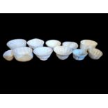 A COLLECTION OF ELEVEN VICTORIAN CREAM GLAZE POTTERY JELLY MOULDS Various embossed designs, one