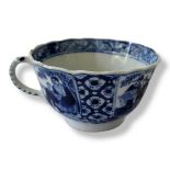 A 19TH CENTURY CHINESE EXPORT BLUE AND WHITE PORCELAIN WINE CUP Having a single handle and decorated