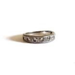 A VINTAGE WHITE METAL AND DIAMOND HALF ETERNITY RING Set with a row of eight round cut diamonds in a