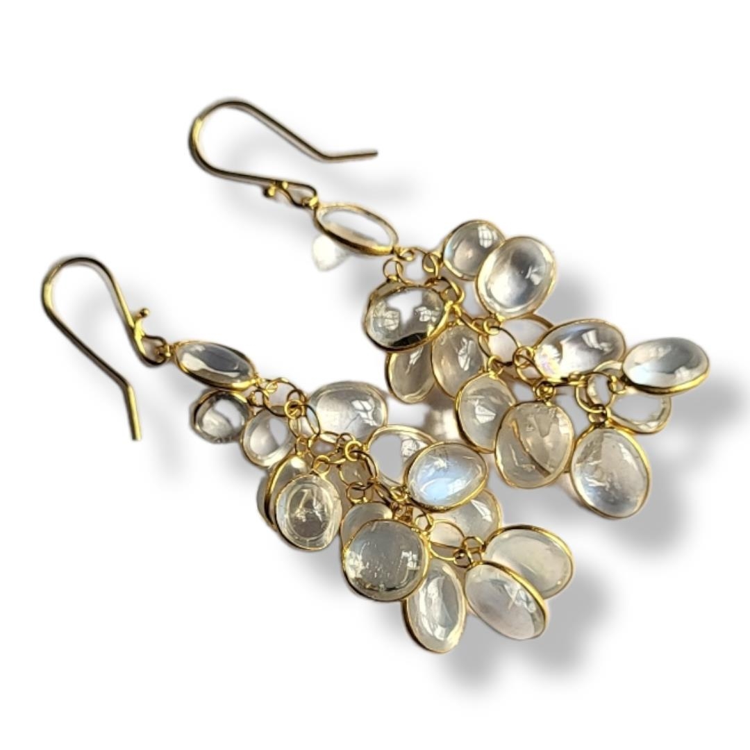 A PAIR OF YELLOW METAL AND MOONSTONE EARRINGS Having an arrangement of oval cut stones forming a