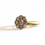 A VINTAGE 18CT GOLD AND DIAMOND CLUSTER RING Having an arrangement of round cut diamonds in a