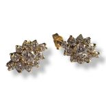 A PAIR OF 9CT GOLD AND CUBIC ZIRCONIA EARRINGS Having an arrangement of round cut stones in a