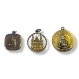 A COLLECTION OF 9CT GOLD PENDANTS Comprising a Buddha pendant set with a single diamond, a Virgo