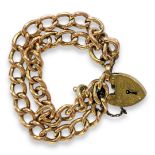 AN EARLY 20TH CENTURY 9CT GOLD BRACELET Having double oval links with heart form clasp. (approx 8cm)