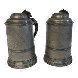 A PAIR OF VICTORIAN PEWTER AND GLASS LIDDED TANKARDS Having a dome form hinged lid and glass base,