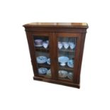 A VICTORIAN MAHOGANY FLOOR STANDING BOOKCASE With two glazed doors, on a plinth base. (90cm x 30cm x