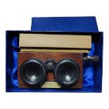 AN EARLY 20TH CENTURY MAHOGANY CASED STEREOSCOPE With glass slides, one slide damaged corners.