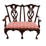 A 20TH CENTURY GEORGIAN DESIGN MAHOGANY TWO SEAT CHAIR SETTEE With pierced vase splat backs, newly