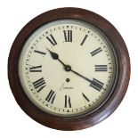 GARRARD, AN EARLY 20TH CENTURY OAK CIRCULAR STATION WALL CLOCK With cream tone dial and key wind