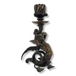A 19TH CENTURY CONTINENTAL CAST BRONZE SINGLE CANDLESTICK MODELLED AS A MYTHOLOGICAL SEMICLAD WINGED