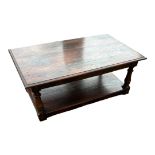A 19TH CENTURY STYLE SOLID OAK COFFEE TABLE With under tier. (122cm x 74cm x 47cm)