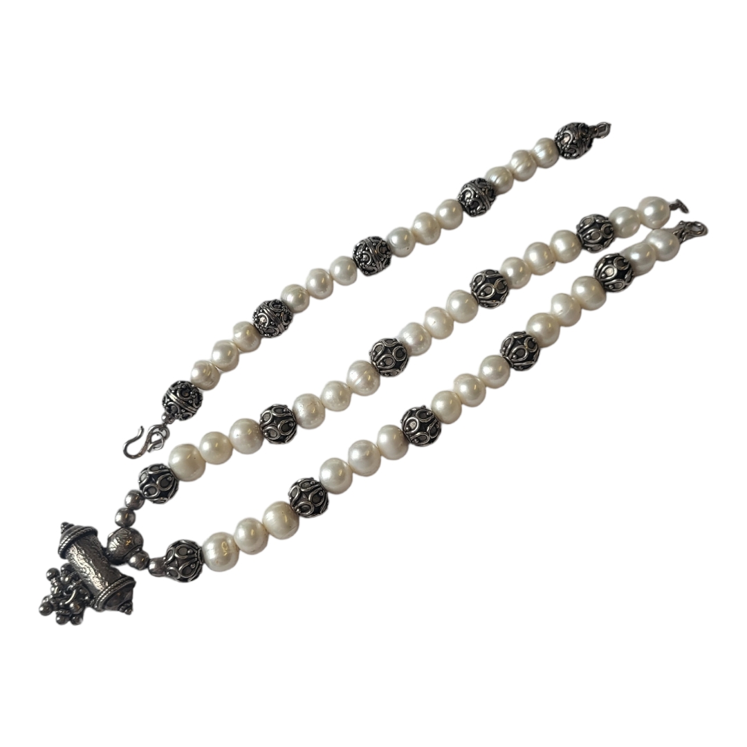 A PERSIAN WHITE METAL AND PEARL NECKLACE AND BRACELET SET Having rows of three pearls interspersed