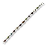 A WHITE METAL AND GEMSTONE 'TUTTI FRUTTI' BRACELET Having a row of oval cut stones to include