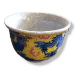A 20TH CENTURY CHINESE BLUE AND YELLOW TEA BOWL Decorated with a dragon and Phoenix, bearing a six