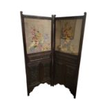 AN EDWARDIAN MAHOGANY TWO FOLD SCREEN With later floral needlework panels above decorative carved