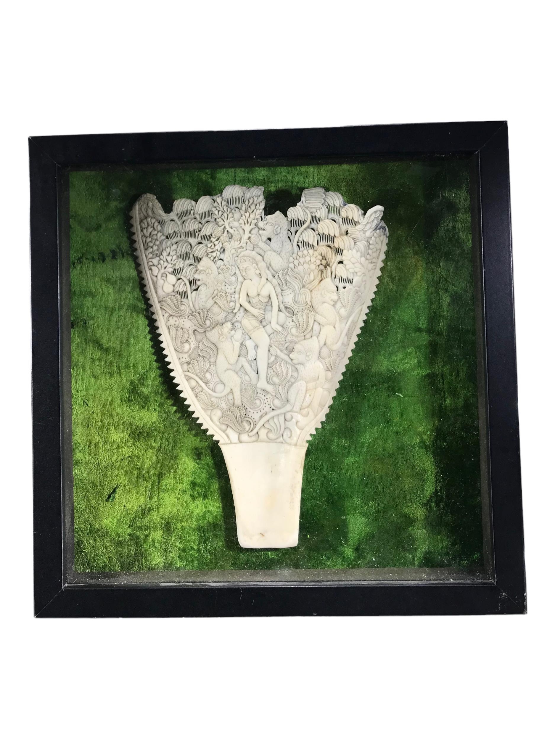 A 19TH CENTURY CARVED BONE SCAPULA Depicting a Goddess and monkeys amongst vines, fruit and