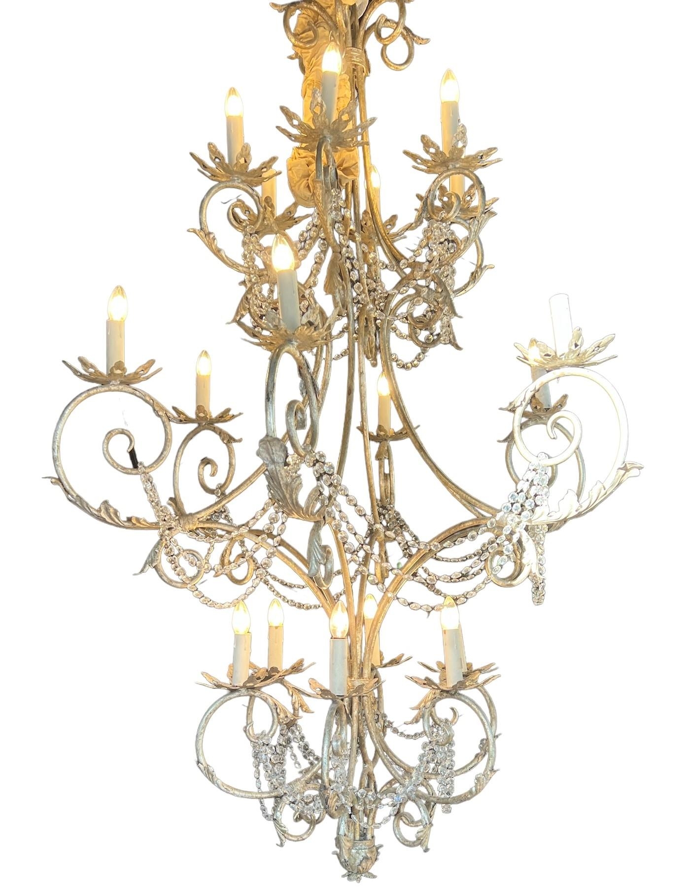 A HUGE DECORATIVE SILVER GILT METAL AND CRYSTAL GLASS DROP CHANDELIER With twelve scrolling arms and